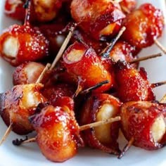 bacon wrapped in toothpicks on a white plate