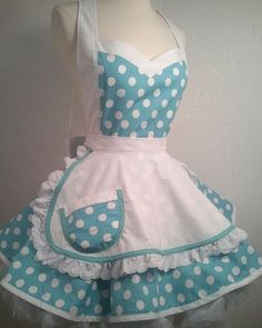 a white and blue polka dot apron dress on a mannequin headdress