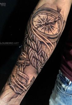 a man with a tattoo on his arm has a compass and rope in the middle