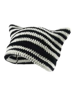 a black and white striped pillow sitting on top of a table