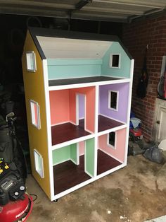 a multicolored doll house sitting in the garage