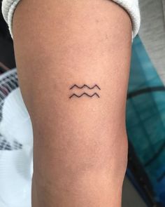 a woman's arm with a small tattoo on the left side of her leg