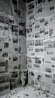 an old bathroom with newspapers covering the walls