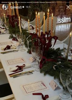 the table is set with place cards and candles