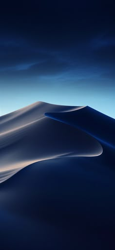 the sky is dark blue and there are clouds in the background that appear to be white sand dunes