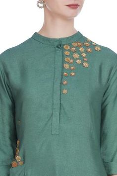 For a traditional look at work, pick this green silk blend tunic. It features 3D flower motif embroidery. Team it up with gold-toned pants to complete the look. 
Mandarin collar
Utility pockets
Three quarter sleeves - Aza Fashions Cotton Silk Straight Kurta With Yoke, Long Sleeve Chanderi Kurta With Embroidered Neckline, Chanderi Kurta With Embroidered Neckline And Long Sleeves, Embroidered Green Cotton Silk Kurta, Green Embroidered Cotton Silk Kurta, Traditional Straight Kurta With Embroidered Neckline, Chanderi Long Sleeve Kurta With Yoke, Designer Chanderi Kurta With Yoke Detail, Traditional Chanderi Kurta With Embroidered Neckline