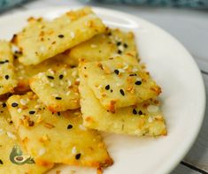 there are some crackers on the plate with sesame seeds and seasoning sprinkles