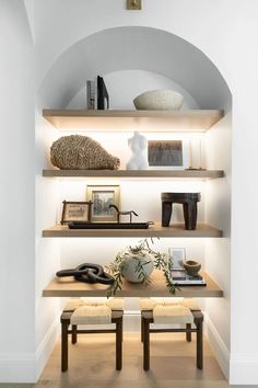 the shelves in this room are filled with books, vases and other decorative items