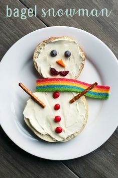 a white plate topped with a frosted snowman sandwich