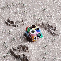 an odd looking object sitting in the middle of a floor covered with confetti