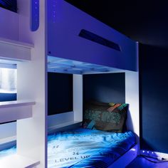 a bunk bed with blue lighting in a room