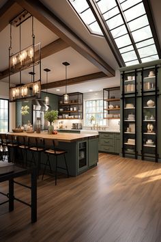 a large kitchen with wooden floors and green cabinetry on the walls, along with an island in the middle