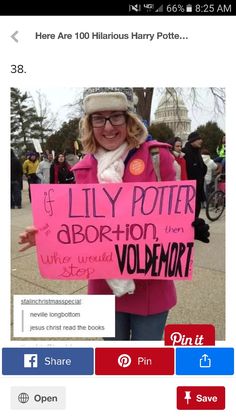 a woman holding a pink sign that says lily potter aborn - on vollmort