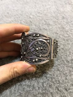 A beautiful antique Algerian silver bracelet with Morocco silver marks, silver filigree, with a sliding pin closure. Handmade from 80 percent silver. The filigree is in good condition and the bracelet functions as it should. It is in general in good vintage condition. Width of large side : 5cm Width of small side : 2,8 cm Inner diameter : 5,9cm Weight : 67,9g Traditional Adjustable Filigree Bracelets, Adjustable Traditional Filigree Bracelets, Ornate Antique Silver Carved Jewelry, Bohemian Filigree Cuff Bracelet, Antique Silver Bracelet With Intricate Design, Bohemian Antique Silver Bracelet With Intricate Design, Traditional Filigree Cuff Bracelet Bangle, Ornate Handmade Antique Silver Bracelet, Traditional Filigree Cuff Bangle Bracelet