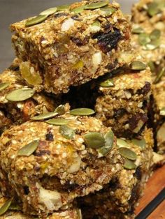 granola bars stacked on top of each other with nuts and seeds in the middle