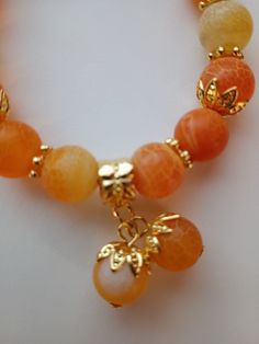 10mm orange crackle agate with bead bobble charms7.78 inch stretch bracelet Cheap Orange Beaded Bracelets, Cheap Orange Bead Bracelets, Adjustable Orange Agate Bracelet, Adjustable Orange Agate Bracelets, Orange Agate Gemstone Bead Bracelets, Orange Agate Gemstone Beads Bracelet, Orange Beaded Bracelet With Natural Stones, Orange Stretch Bracelet With Large Beads As Gift, Gift Orange Stretch Bracelet With Large Beads