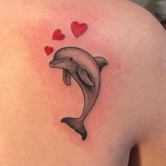 a dolphin with hearts floating out of it's back