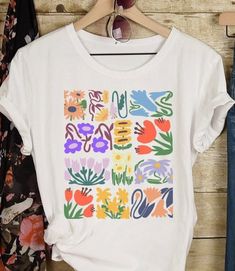 Matisse Boho Flower Shirt Wildflowers Nature Tshirt Floral T Shirt Botanical Art Nouveau Deco Gift for her  This classic Bella canvas unisex jersey short sleeve tee fits like a well-loved favorite. Soft cotton and quality print will make you fall in love with it over and over again. These t-shirts have-ribbed knit collars to bolster shaping. The shoulders have taping for better fit over time. Dual side seams hold the garment's shape for longer.  S H I P P I N G IMPORTANT: Please note that we ship to the address provided at check out. If you are ordering this as a gift and wish to have it shipped elsewhere, please enter the correct address at check out. If an incorrect shipping address was given and the gift is returned back to our shop, the customer is responsible for paying the re-shippin Cheap Oversized Floral Print T-shirt, Tabitha Swatosh Flower Shirt, Floral T Shirt, Diy Tshirt, Dog Stocking, Curated Closet, Garden Club, Solid Color Shirt, Flower Shirt