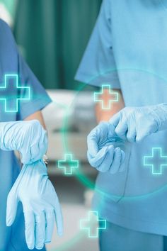 two doctors in blue scrubs and white gloves are holding their hands out to each other