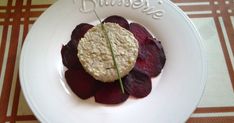 a white plate topped with food on top of a table