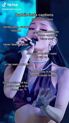 a woman singing into a microphone in front of a screen with the words baddie insa captions