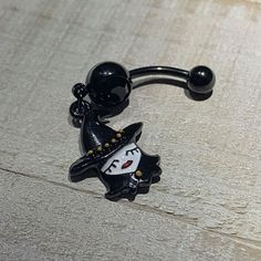 Black Gem Black Pretty Goth Witch Halloween Dangle Belly Ring Don't worry about watching out for scary monsters or creepy-crawlies this Halloween when you wear this 14 gauge belly button ring; you'll be the scariest and prettiest around! Made with a 3/8" black PVD over 316L surgical grade stainless steel curved barbell, this navel ring features a black bottom gem as well as a pretty witch dangle charm that will be a spooky surprise for anyone you meet!Specifications14 Gauge (1.6mm), 3/8" (10mm), Black Spooky Jewelry For Costume Party, Black Novelty Jewelry For Costume Party, Black Vampire Jewelry For Halloween, Vampire Style Black Jewelry For Halloween, Black Halloween Costume Jewelry, Spooky Black Jewelry For Halloween, Black Witchy Jewelry For Halloween, Witchy Black Jewelry For Halloween, Witchy Black Halloween Jewelry