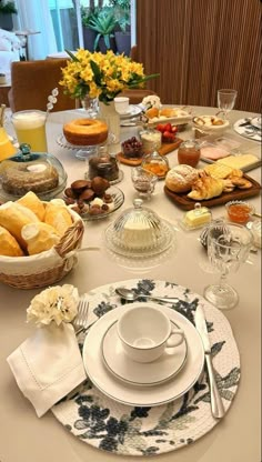 the table is set with plates and cups