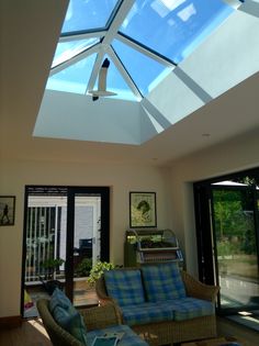 a living room filled with furniture and a skylight