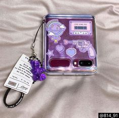 a cell phone case with some stickers on it and a lanyard keychain