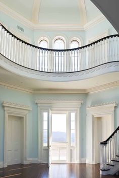 an empty room with stairs leading up to the second floor