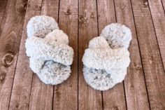 a pair of slippers sitting on top of a wooden floor