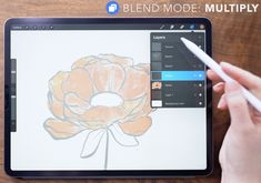 someone is drawing a flower on an ipad