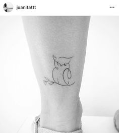 a small tattoo on the ankle of a woman's leg with an owl sitting on it