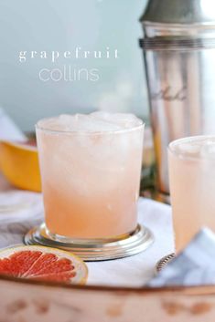 grapefruit collinss on a table with orange slices