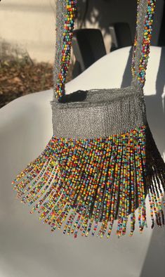 beaded purse sitting on top of a white table