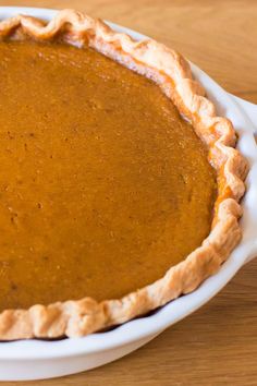 a pumpkin pie sitting on top of a wooden table