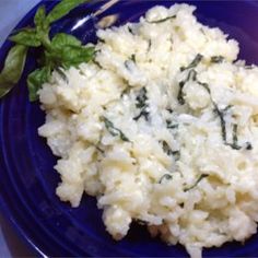 a blue plate topped with rice and spinach