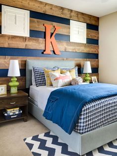 a bedroom decorated in blue and white with wood accenting the walls, along with two nightstands on either side of the bed