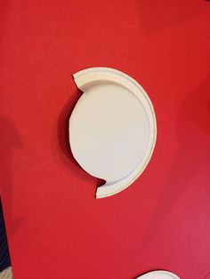 a red table with a white plate on it