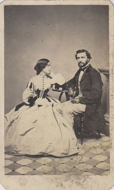 an old fashioned photo of a man and woman