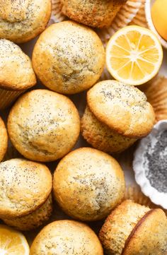 lemon poppy seed muffins on a plate next to orange slices and cupcake tins