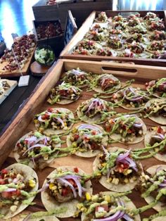 many tacos are lined up on a table