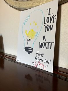 This is a photo of a lightbulb drawn on grey craft paper. There is a light blue bulb surrounding a yellow toddler handprint and a dotted heart indicating the power of love lighting up the bulb. The text reads. I LOVE YOU A WATT Happy Father’s Day!  Signed scribble by toddler. Dated 2023. Fathers Day Art, Father's Day Activities, Kids Daycare, Father's Day Diy, Daycare Crafts, Creative Craft