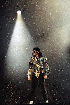 michael jackson performing on stage in front of spotlights