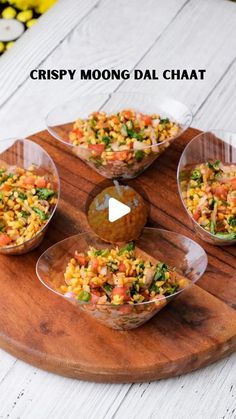 three bowls filled with food sitting on top of a wooden tray