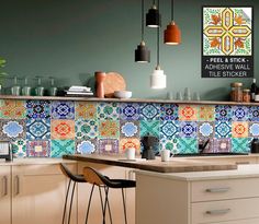 a kitchen with colorful tiles on the wall