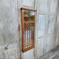 an old wooden door with a mirror on it