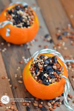 an orange with seeds in it sitting on a wooden table