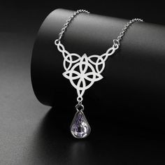 ⚜️Looking for a stunning piece of jewelry that exudes both style and spirituality? Look no further than our Celtics Knot Necklace! Crafted with Stainless Steel and adorned with a mesmerizing Crystal Rhinestone, this necklace will add a touch of magic to any outfit. Complete with an elegant pendant size of 32.5*27.9mm, it's the perfect accessory for any witch or crystal lover. Add it to your collection today and let its powerful energy guide you on your journey! ✨🔮 Crystal Teardrop Pendant Clavicle Necklace, Crystal Clavicle Chain Necklace With Teardrop Pendant, Symbolic Metal Clavicle Chain Jewelry, Silver Crystal Pendant Necklace With Jewels, Silver Pendant Crystal Necklace With Jewels, Bohemian Silver Crystal Clavicle Chain Necklace, Bohemian Silver Crystal Necklace With Clavicle Chain, Spiritual Stainless Steel Clavicle Chain Necklace, Spiritual Stainless Steel Clavicle Necklace