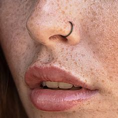 a woman with freckles on her face and nose